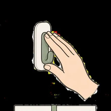 壁に粘着フックを押し当てる手